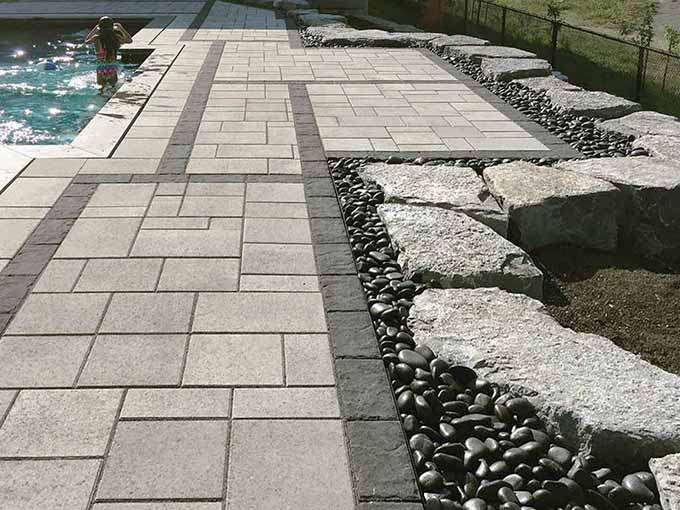 Interlock patio with pool and stone retaining wall