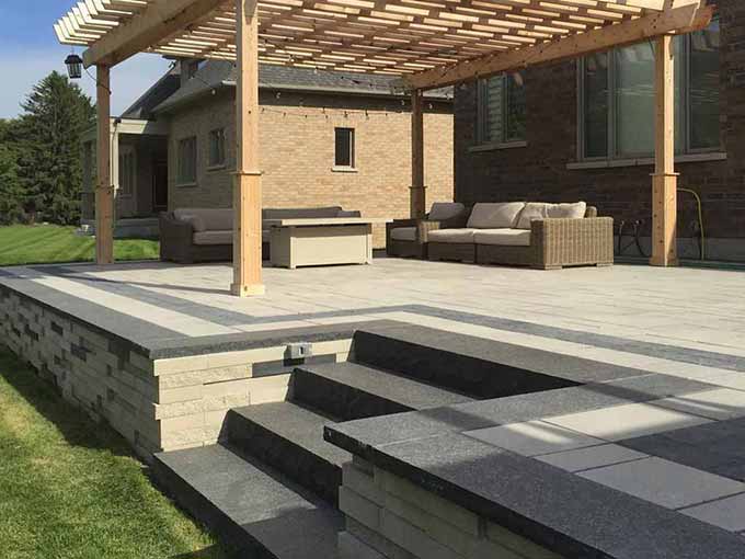 Interlock patio with pergola in a backyard