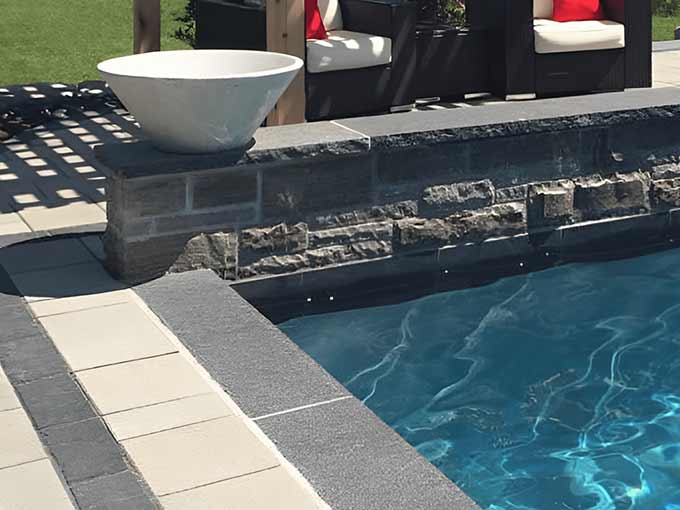 Luxury poolside interlock patio with stonework by Greenblock