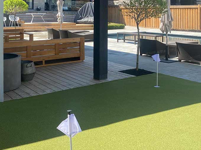 Sophisticated outdoor patio with interlock and synthetic turf