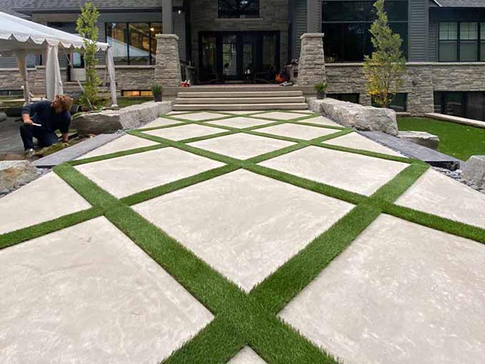 Interlock patio with synthetic grass inlays by Greenblock