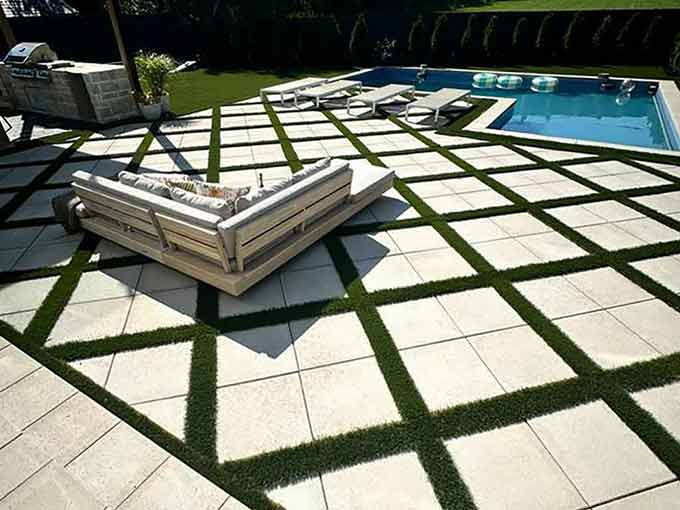 Luxurious backyard with interlock patio and pool by Greenblock Landscape