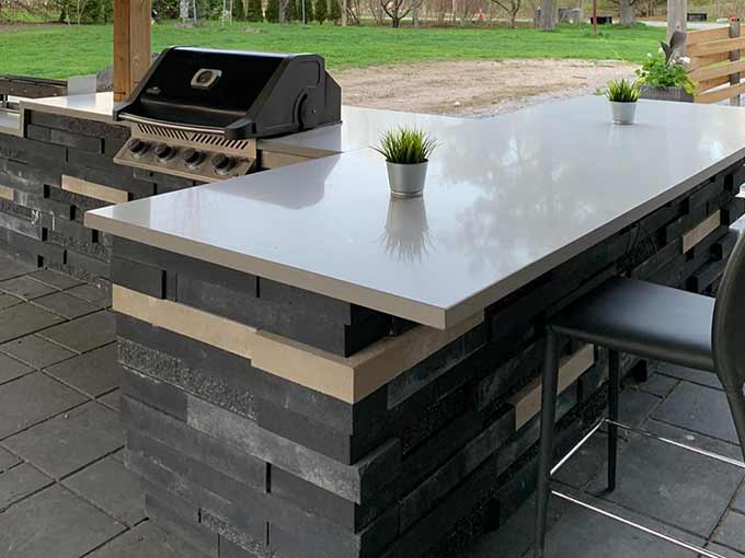 Luxury outdoor kitchen with stone veneer and grill