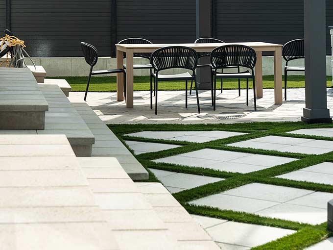 Modern interlock patio with geometric design and seating area by Greenblock