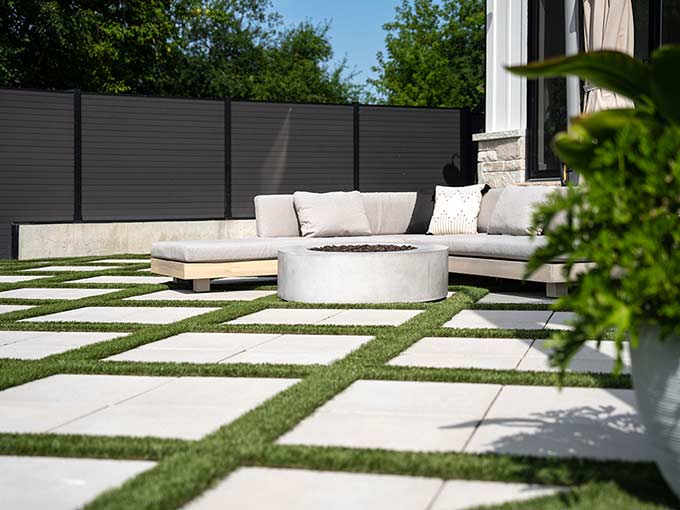 Outdoor lounge with interlock patio and synthetic grass
