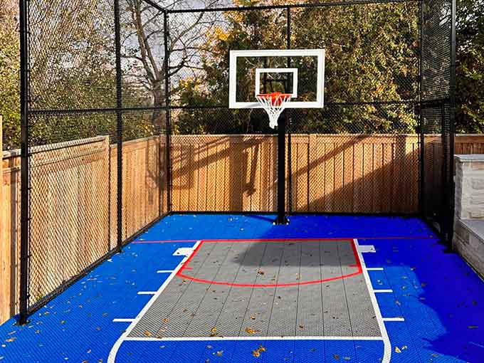 Backyard basketball court with blue surface and hoop
